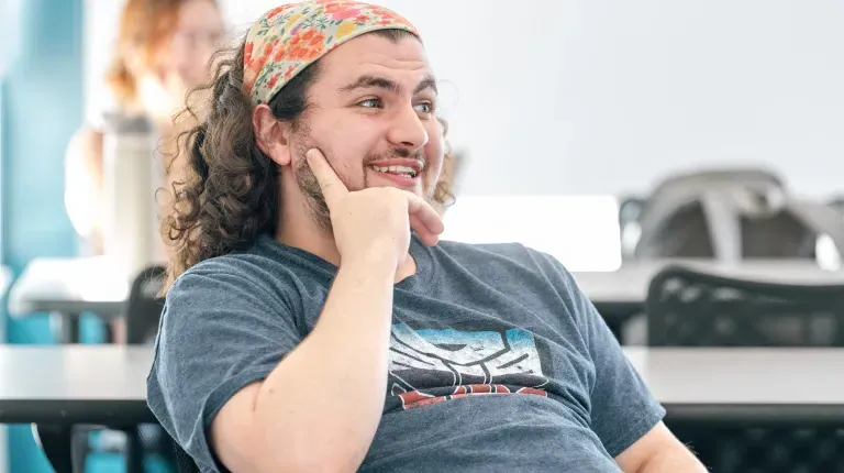 A UNE student smiles during classroom discussion