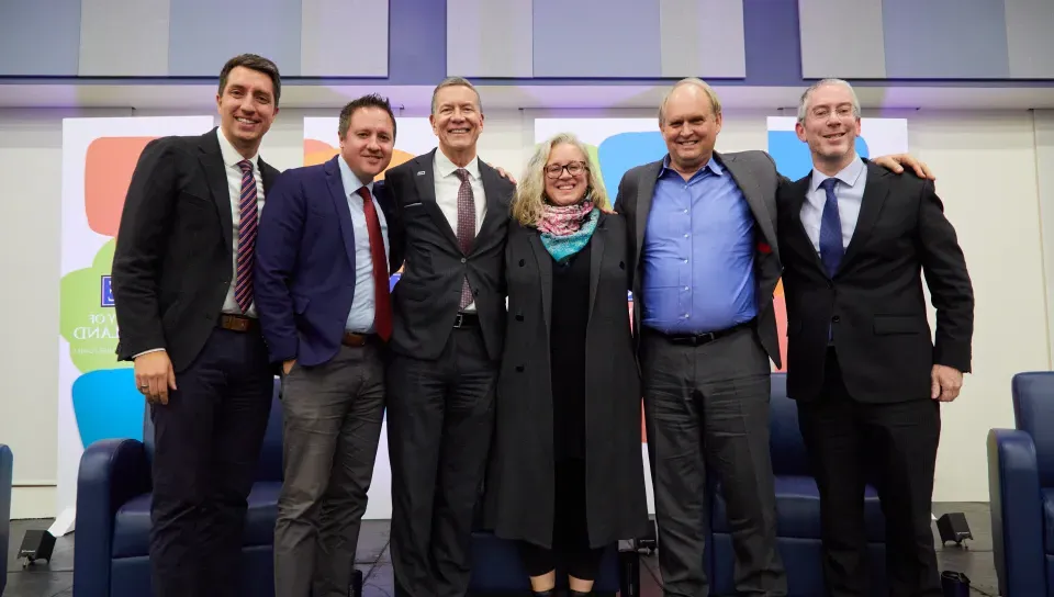 Panelists, moderator, and UNE President James Herbert and 